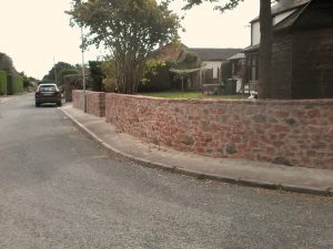 Newly built perimeter wall in red sandstone