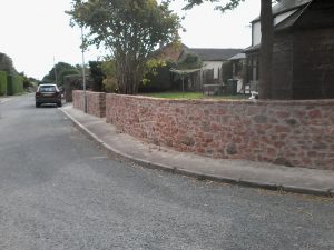 replaced with red sandstone perimeter wall