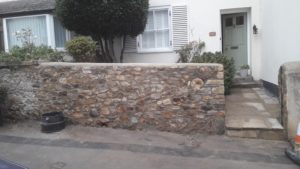wall was dismantled and rebuilt using stones of flint; owners delighted.